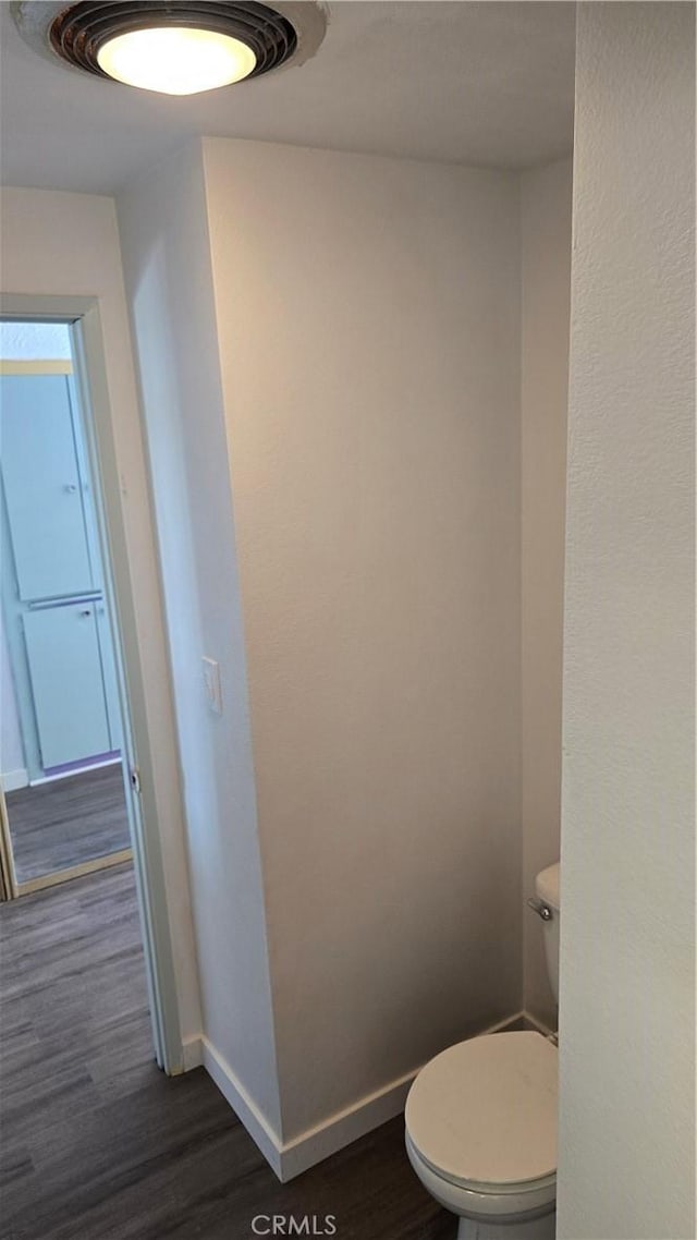 bathroom featuring hardwood / wood-style floors and toilet