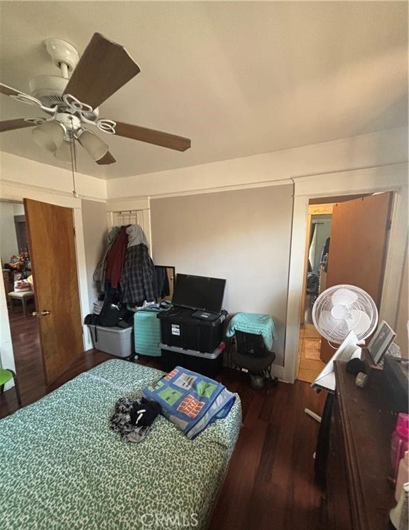 bedroom with ceiling fan and dark wood-type flooring