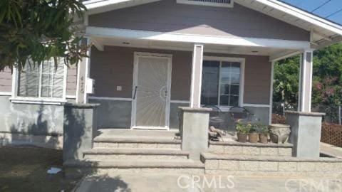 doorway to property with covered porch