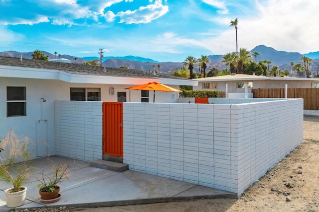 view of front facade featuring a patio area and a mountain view