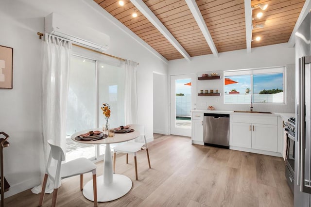 kitchen featuring appliances with stainless steel finishes, vaulted ceiling with beams, a wealth of natural light, and wooden ceiling