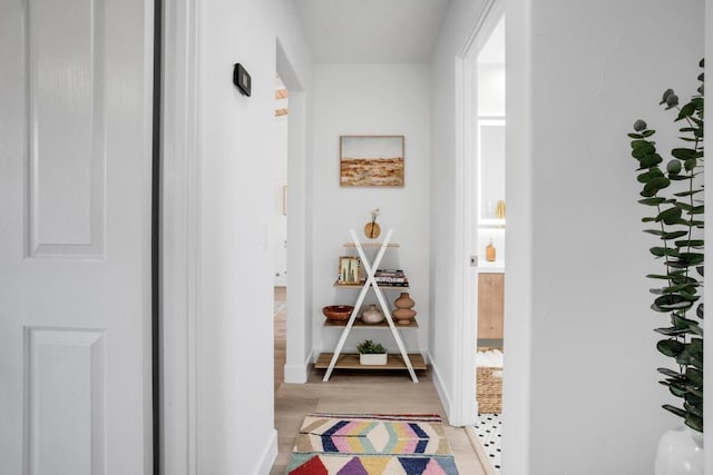 hallway with light hardwood / wood-style floors