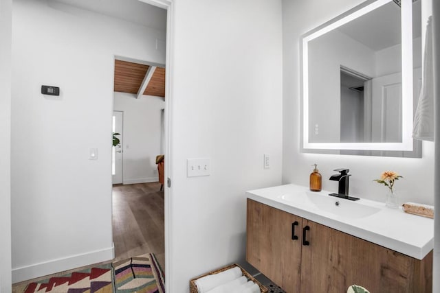 bathroom with vanity, hardwood / wood-style flooring, lofted ceiling, and wood ceiling