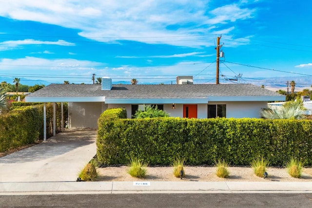 single story home with a carport