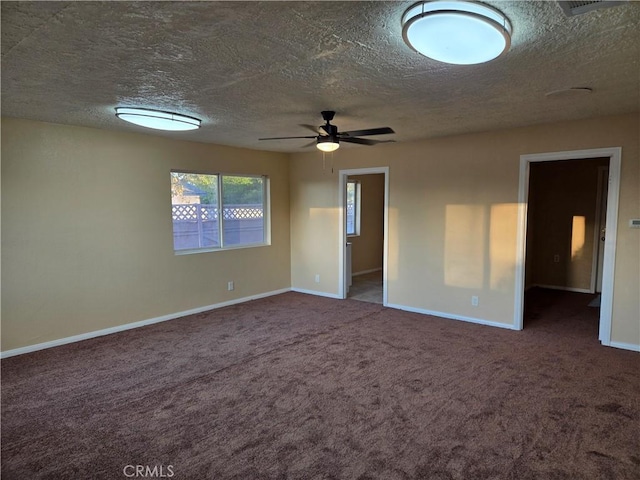 unfurnished room featuring ceiling fan, a textured ceiling, and dark colored carpet