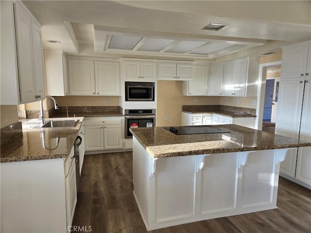 kitchen featuring sink, white cabinetry, stainless steel appliances, and dark wood-type flooring