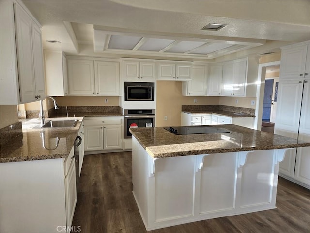 19345 Oneida Rd, Apple Valley, CA 92307 - kitchen featuring oven, a sink, built in microwave, dark wood-style flooring, and black electric cooktop