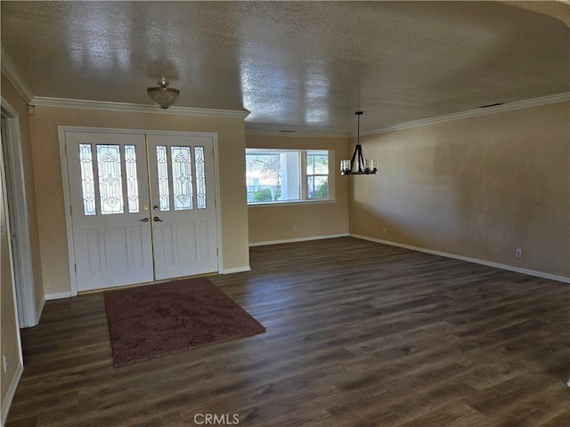 entryway with a chandelier, a textured ceiling, crown molding, and dark wood-type flooring