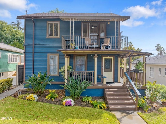 view of front of home with a balcony, a front lawn, and a porch