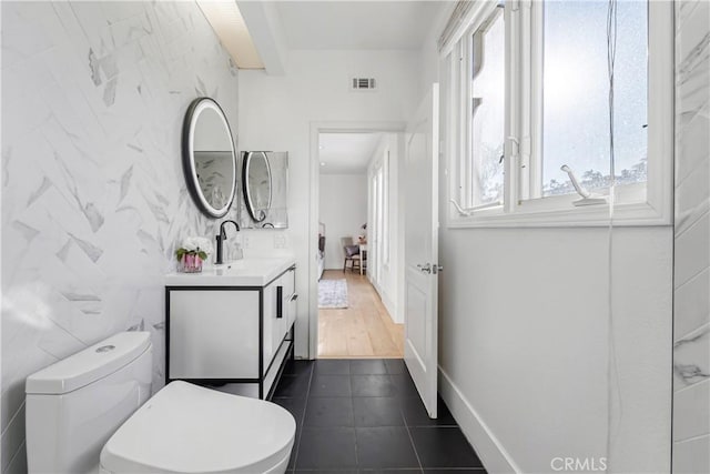 bathroom with vanity, hardwood / wood-style flooring, toilet, and tile walls