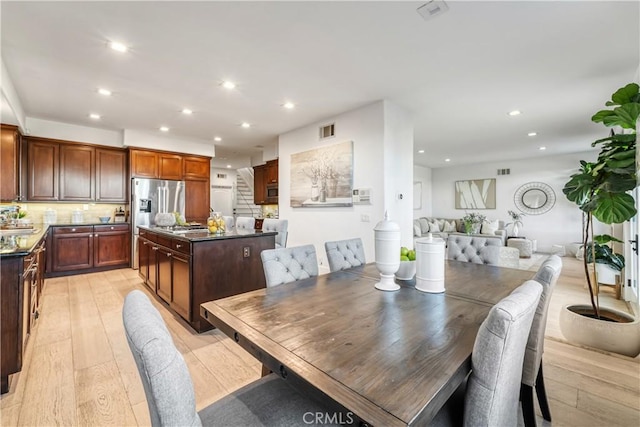 dining room featuring sink and light wood-type flooring