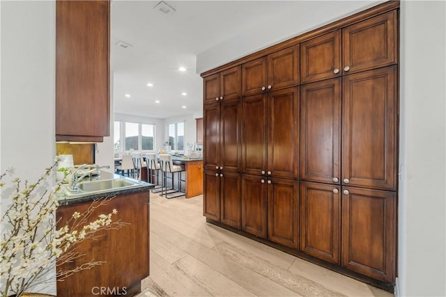 kitchen with sink and light hardwood / wood-style flooring