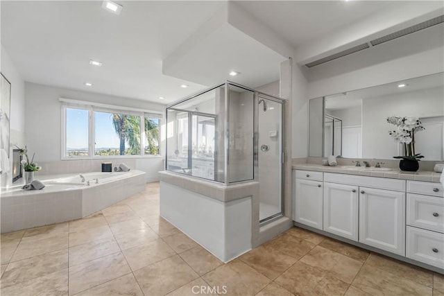 bathroom featuring tile patterned floors, vanity, and plus walk in shower