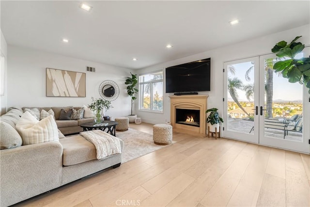 living room with french doors and light hardwood / wood-style floors