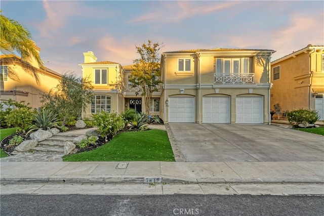 view of front of property with a yard and a garage