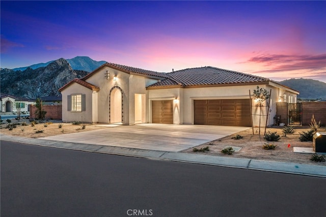 mediterranean / spanish-style house with a mountain view and a garage