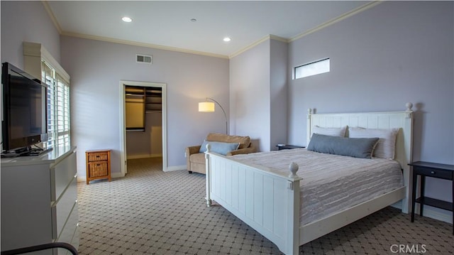 carpeted bedroom featuring a spacious closet, a closet, and ornamental molding