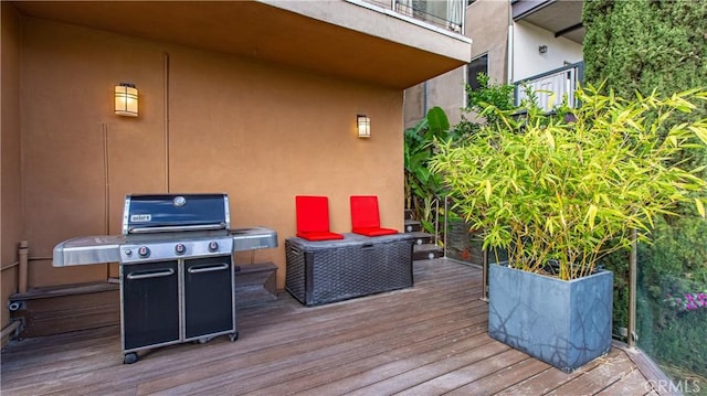 wooden terrace with a grill