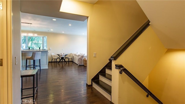 stairway with hardwood / wood-style floors