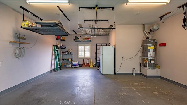 garage with strapped water heater and white fridge