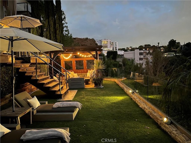 yard at dusk with outdoor lounge area