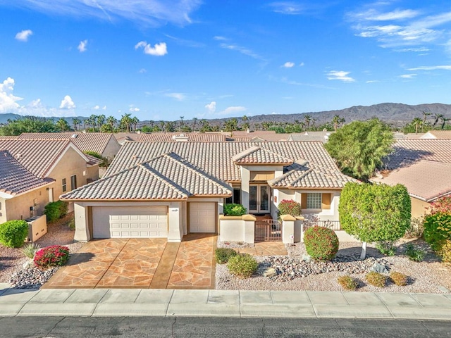 view of front of home with a mountain view and a garage