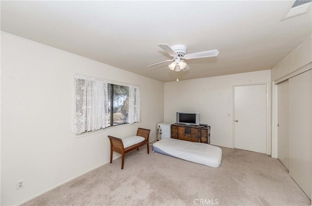 living area with ceiling fan and light colored carpet