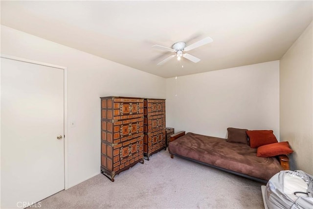 sitting room with ceiling fan and light colored carpet