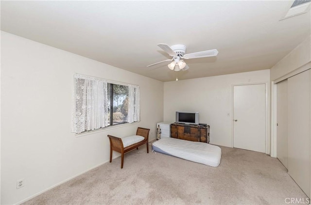 sitting room featuring light carpet and ceiling fan