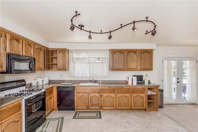 kitchen featuring light tile patterned flooring, french doors, sink, and black appliances