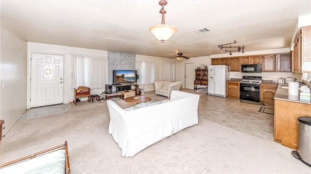 living room featuring ceiling fan and light colored carpet