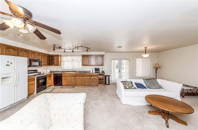 living room featuring french doors and ceiling fan