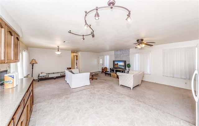 carpeted living room with ceiling fan