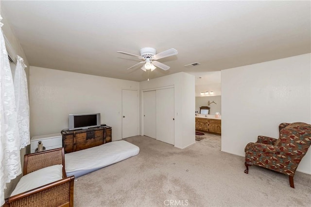 sitting room featuring light carpet and ceiling fan