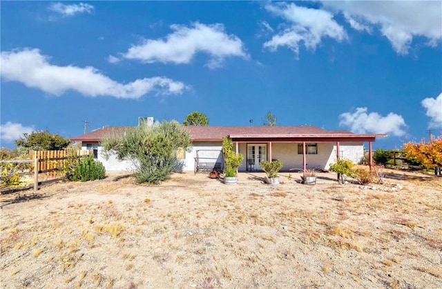 rear view of property featuring french doors