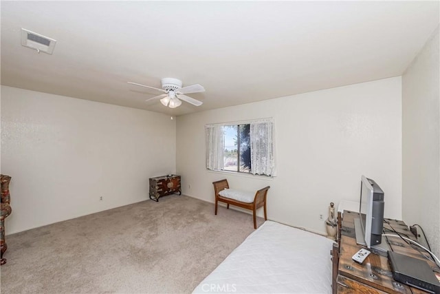 sitting room with ceiling fan and light colored carpet