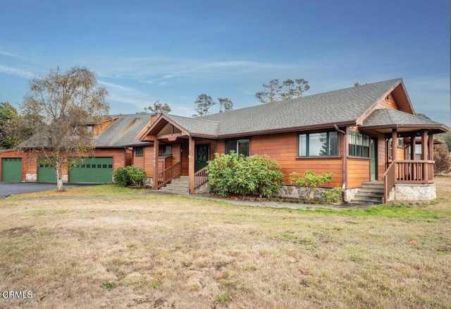 view of front of home featuring a garage and a front lawn