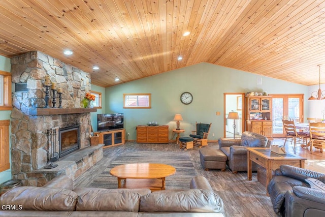 living room with hardwood / wood-style flooring, a stone fireplace, wooden ceiling, and vaulted ceiling