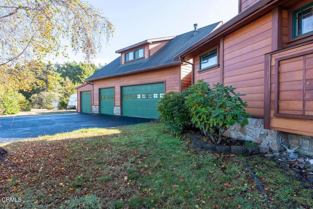 view of side of property with a garage