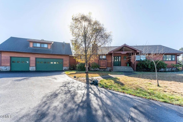 view of front of property with a garage and a front lawn