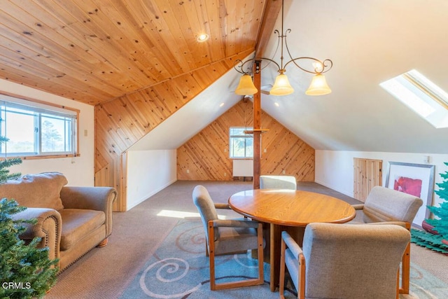 carpeted dining room featuring wood ceiling, wood walls, and vaulted ceiling with skylight