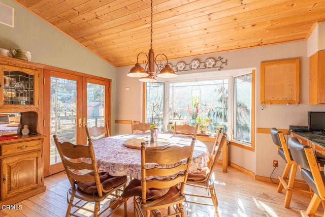 dining room with vaulted ceiling, an inviting chandelier, light hardwood / wood-style flooring, and wood ceiling