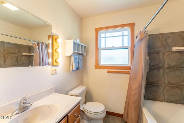 full bathroom featuring toilet, vanity, baseboards, and shower / bath combo with shower curtain
