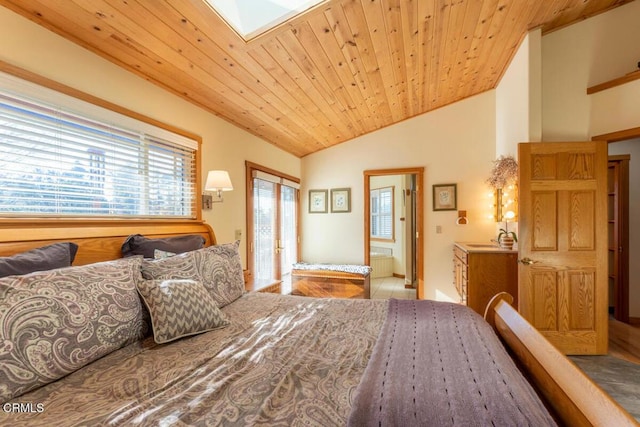 bedroom with tile patterned floors, ensuite bathroom, wooden ceiling, and lofted ceiling with skylight
