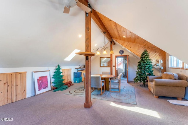 interior space with carpet flooring and vaulted ceiling with beams