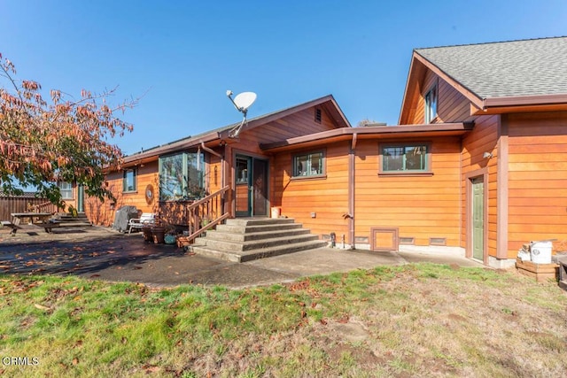 view of front of house featuring a patio and crawl space