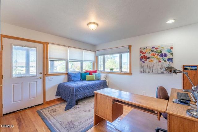bedroom with recessed lighting and wood finished floors