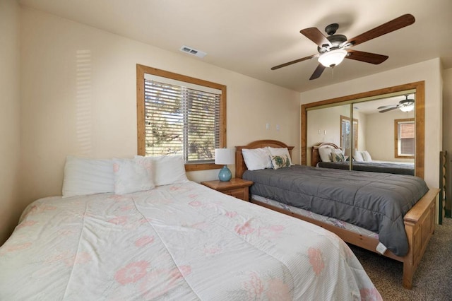 carpeted bedroom with a closet and ceiling fan