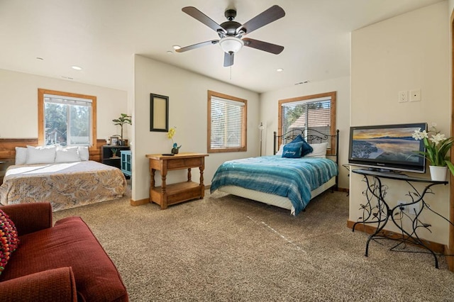 carpeted bedroom with multiple windows and ceiling fan