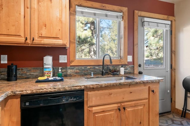 kitchen featuring dishwasher, light stone countertops, sink, and tasteful backsplash